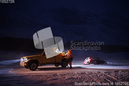 Image of Car being towed after accident in snow storm