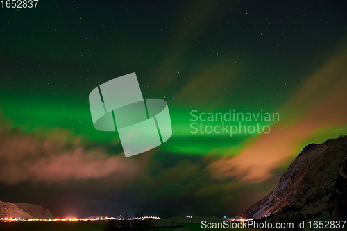 Image of Aurora borealis Green northern lights above mountains