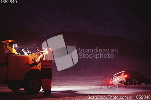 Image of Car being towed after accident in snow storm