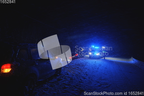 Image of car accident on slippery winter road at night