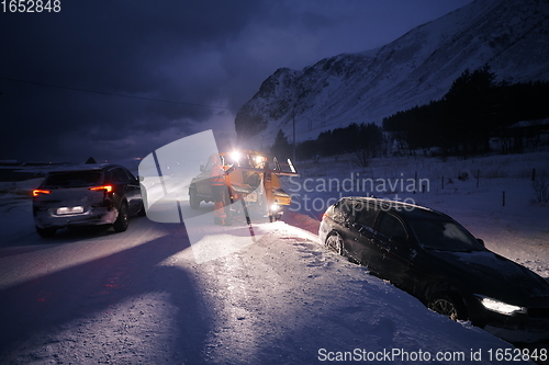 Image of Car being towed after accident in snow storm