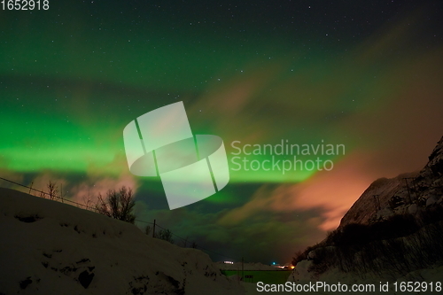 Image of Aurora borealis Green northern lights above mountains