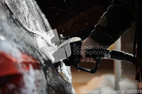 Image of refuelling diesel gas on petrol station at winter