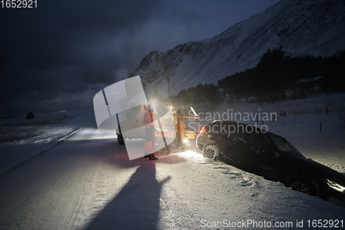 Image of Car being towed after accident in snow storm