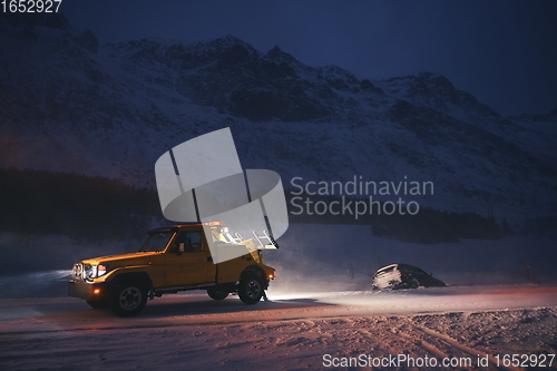 Image of Car being towed after accident in snow storm