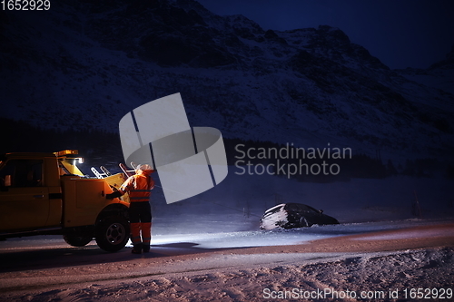 Image of Car being towed after accident in snow storm