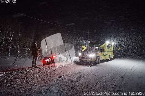 Image of car accident on slippery winter road at night