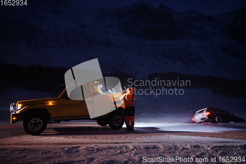 Image of Car being towed after accident in snow storm