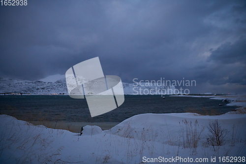 Image of norway coast in winter with snow bad cloudy weather