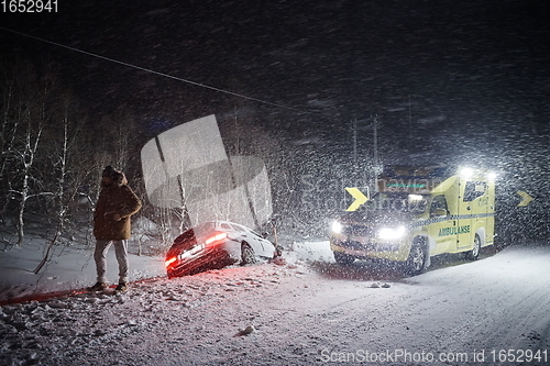 Image of car accident on slippery winter road at night