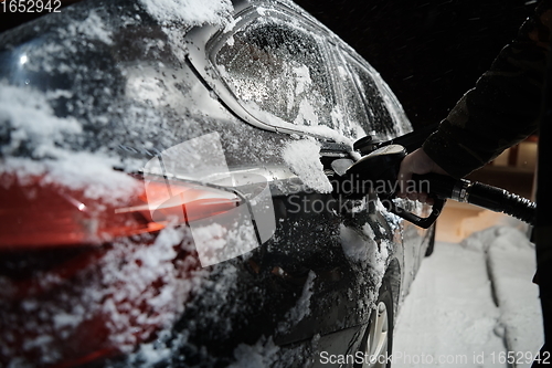 Image of refuelling diesel gas on petrol station at winter