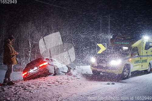 Image of car accident on slippery winter road at night