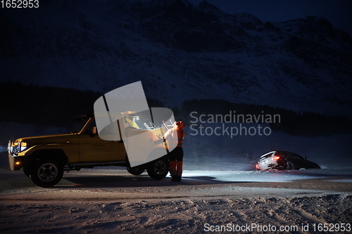 Image of Car being towed after accident in snow storm