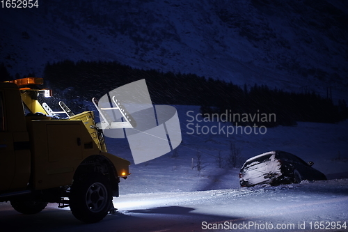 Image of Car being towed after accident in snow storm