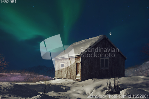 Image of Aurora borealis Green northern lights above mountains