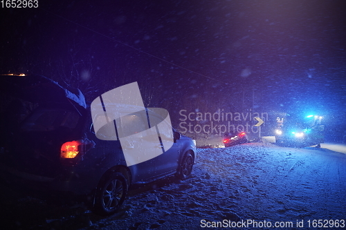 Image of car accident on slippery winter road at night