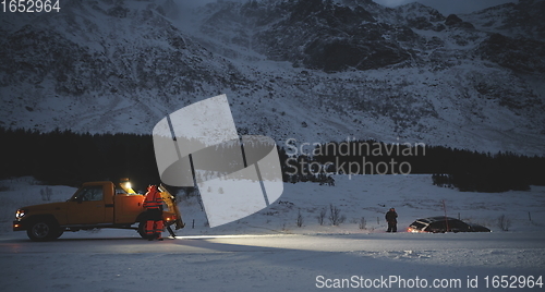 Image of Car being towed after accident in snow storm