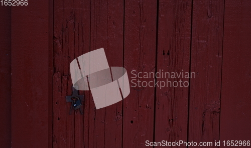 Image of tradidional wooden wall of a red house in Norway