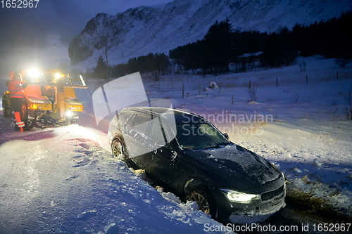 Image of Car being towed after accident in snow storm