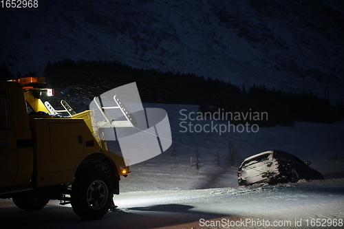 Image of Car being towed after accident in snow storm