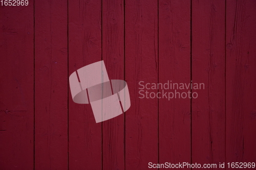 Image of tradidional wooden wall of a red house in Norway