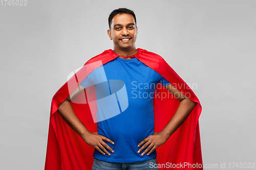 Image of happy smiling indian man in red superhero cape