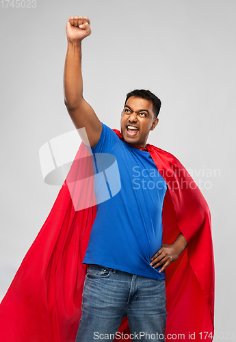 Image of indian man in superhero cape makes winning gesture