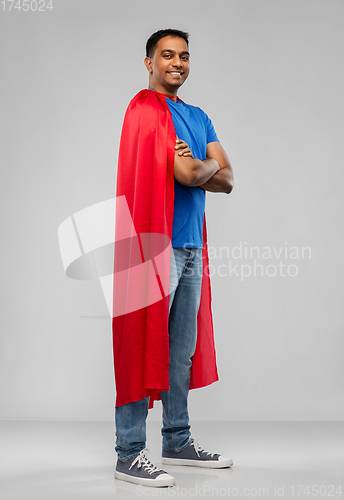 Image of happy smiling indian man in red superhero cape