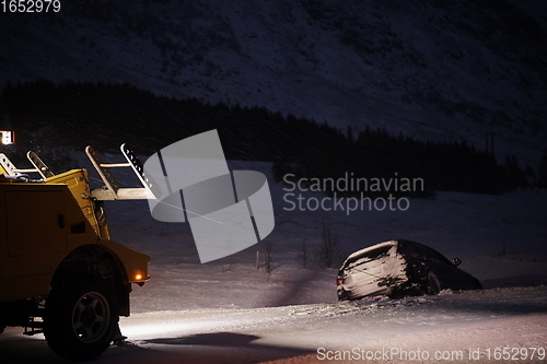 Image of Car being towed after accident in snow storm