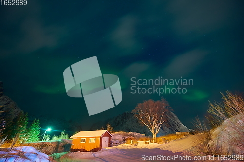 Image of Aurora borealis Green northern lights above mountains