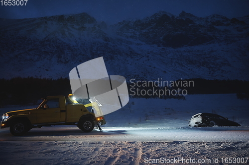 Image of Car being towed after accident in snow storm