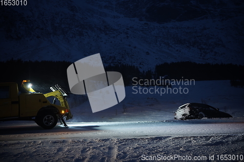 Image of Car being towed after accident in snow storm