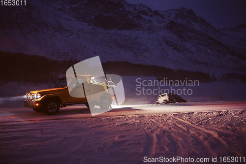 Image of Car being towed after accident in snow storm