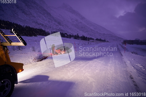 Image of Car being towed after accident in snow storm