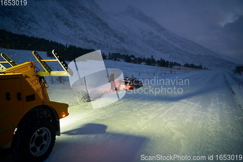 Image of Car being towed after accident in snow storm