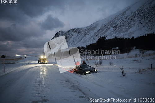 Image of Car being towed after accident in snow storm