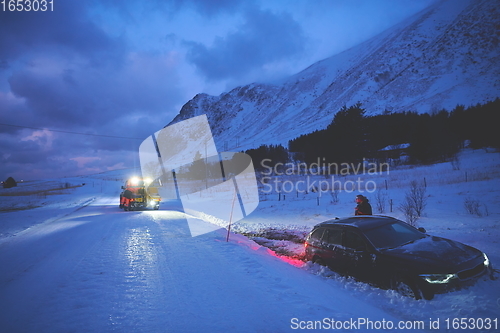 Image of Car being towed after accident in snow storm