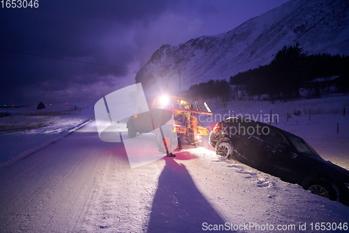 Image of Car being towed after accident in snow storm