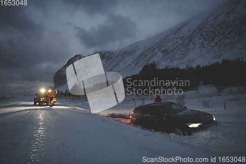 Image of Car being towed after accident in snow storm