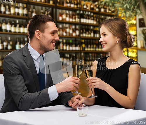 Image of couple with glasses of champagne at restaurant