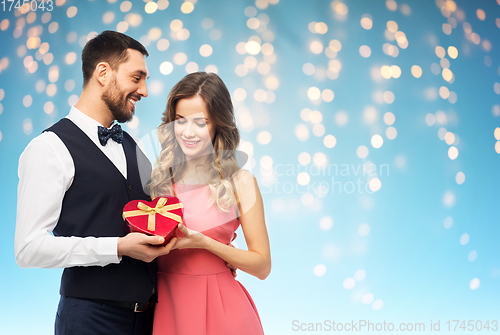 Image of happy couple with gift on valentines day