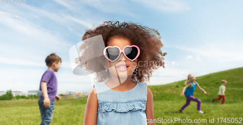 Image of little african girl in sunglasses at summer