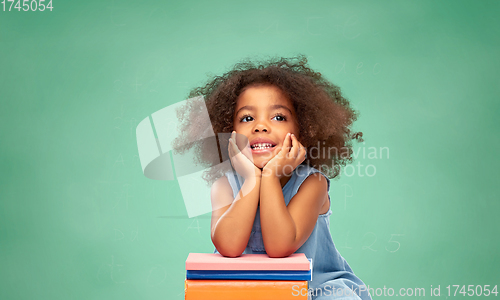 Image of little african american schoolgirl with books