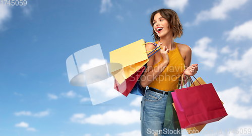 Image of happy smiling young woman with shopping bags