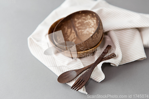 Image of close up of coconut bowl, wooden spoon and fork