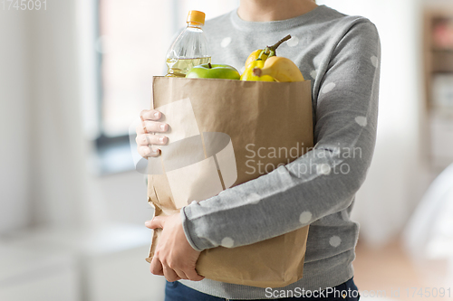 Image of close up of woman with paper bag full of food