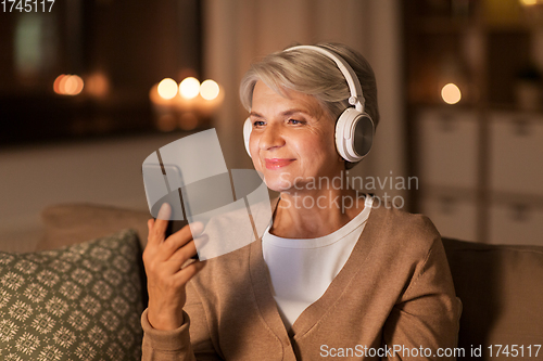 Image of senior woman in headphones listening to music