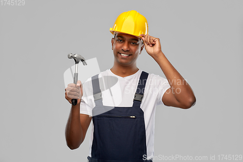 Image of happy smiling indian worker or builder with hammer