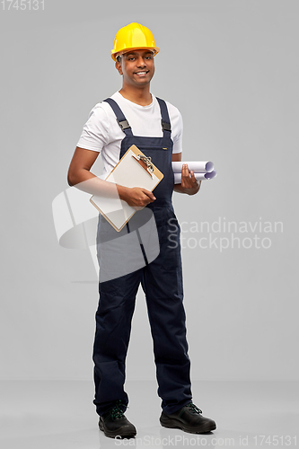 Image of happy indian builder with blueprint and clipboard