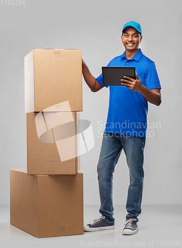 Image of indian delivery man with tablet pc and boxes